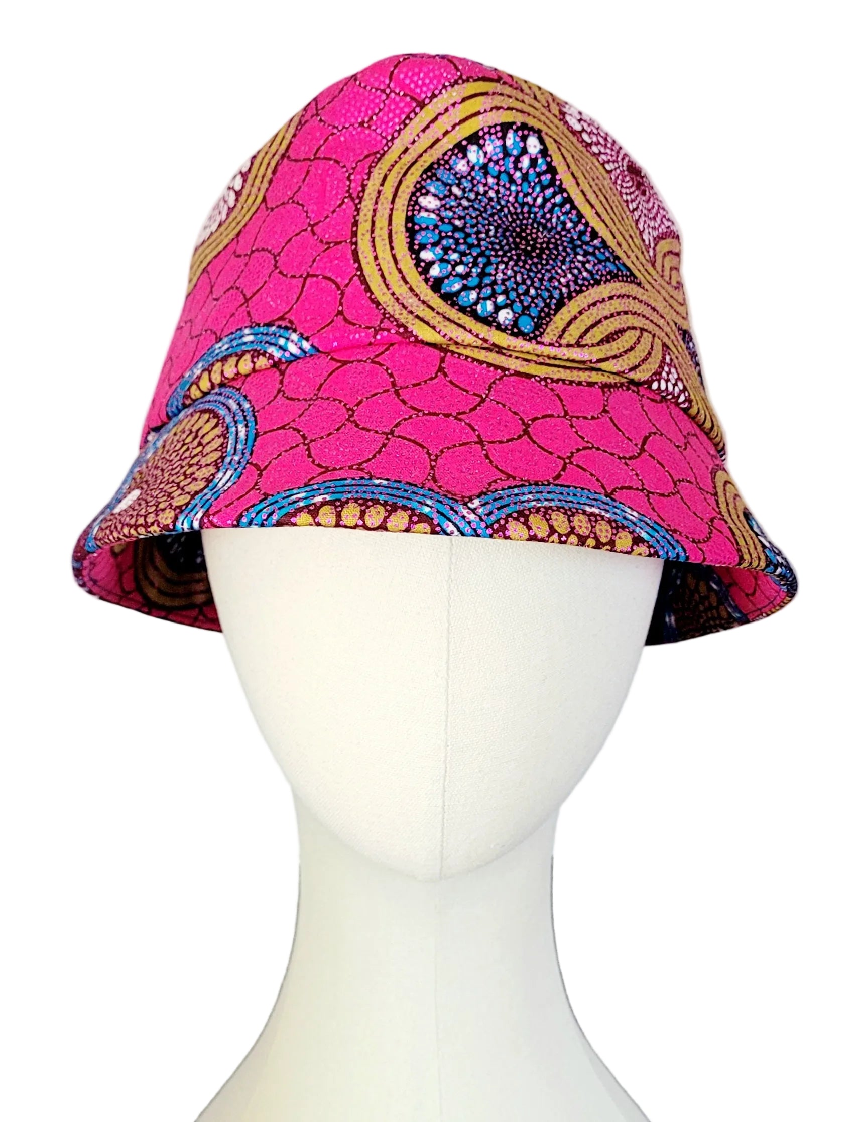 A bucket hat with a vibrant pink and multicolor African wax print pattern, raspberry, teal and copper with golden sheen 