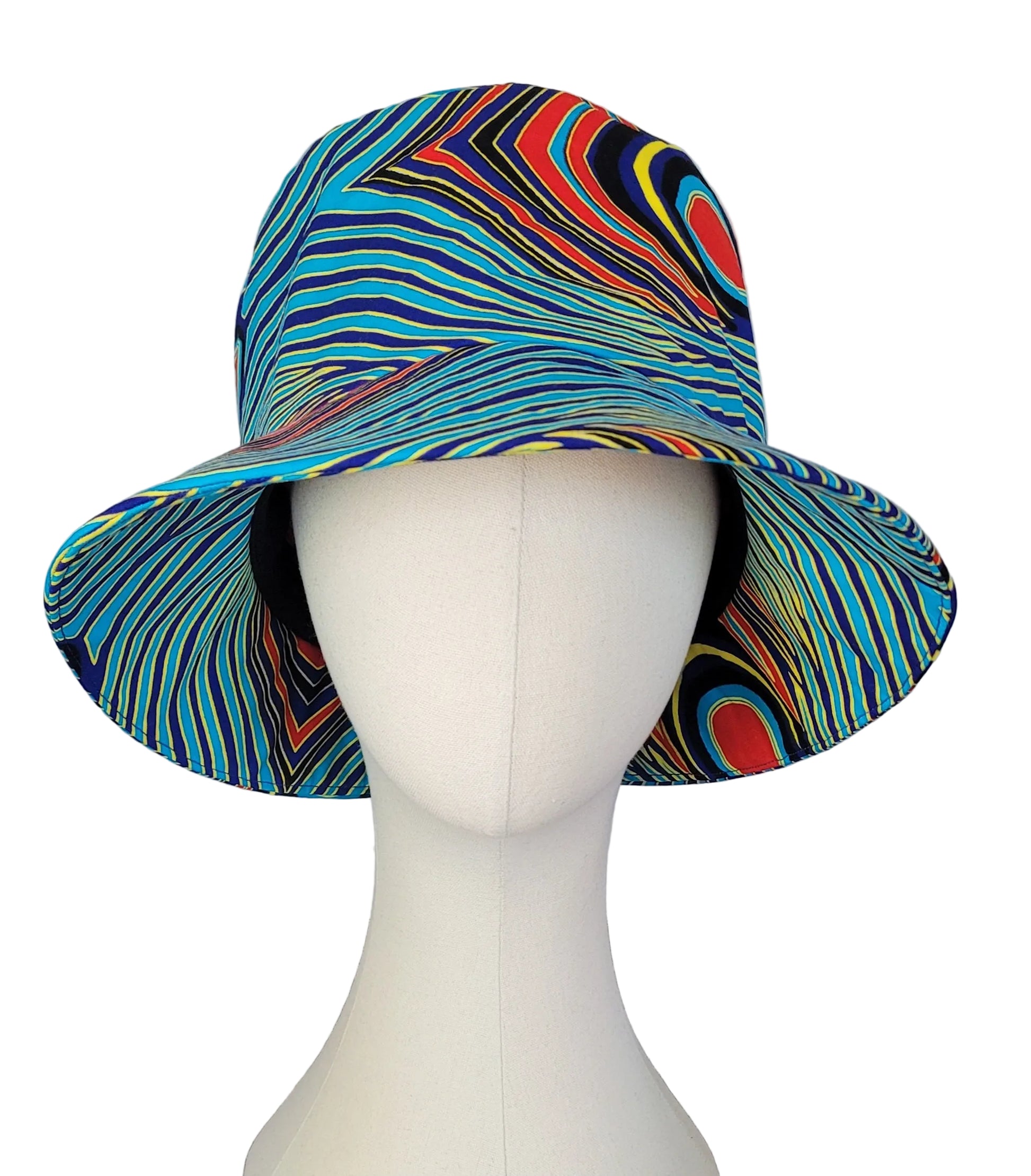 A wide-brimmed bucket hat with a vibrant, multicolored wavy stripe pattern, displayed on a white mannequin head.