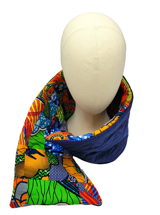 Mannequin head wearing a colorful patterned fabric scarf on a white background